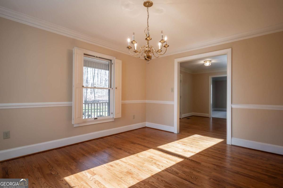 2191 Salem Road Watkinsville, GA 30677 - Photo 7 of 79 a view of an empty room with wooden floor and a window