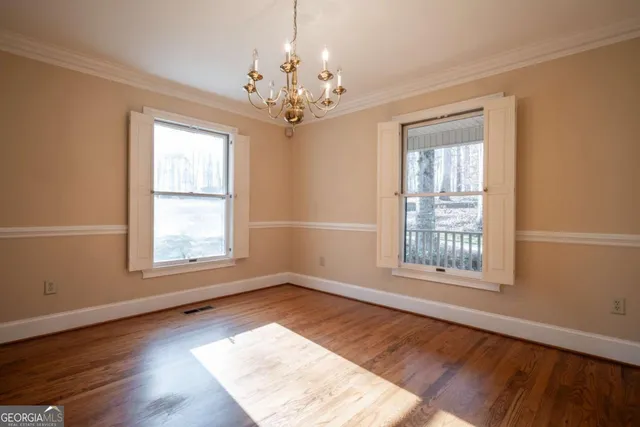 a view of a livingroom with wooden floor and a fireplace