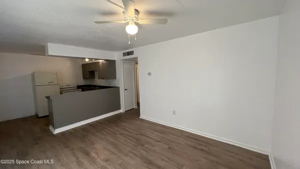 a view of kitchen with hardwood floor and a ceiling fan