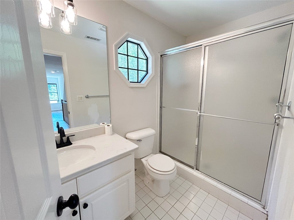 2004 Moores Mill Road Lanett, AL 36863 - Photo 44 of 50 This bright bathroom features sleek tile flooring and a modern shower for daily convenience.