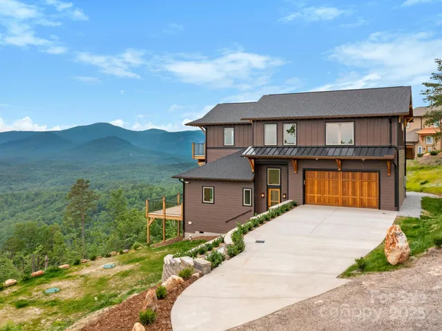 a aerial view of a house with a yard