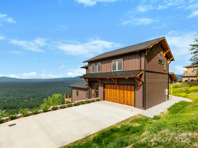 a view of a lush green hillside and a houses