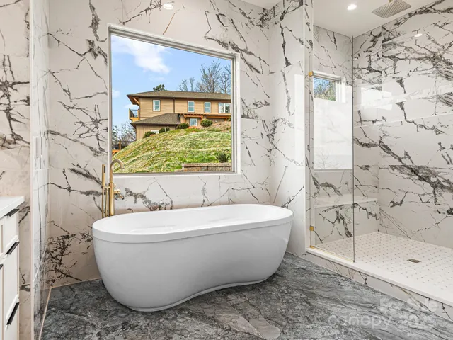 a living room with furniture a fireplace and a chandelier