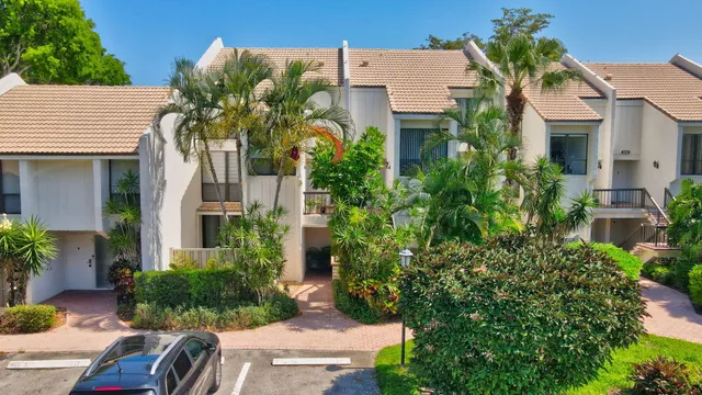 an aerial view of multiple houses with yard