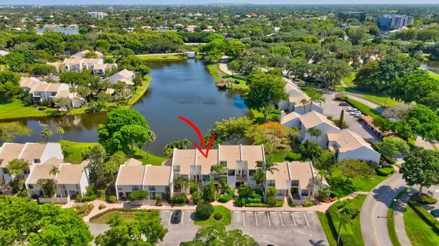 an aerial view of a house with swimming pool a yard and lake view