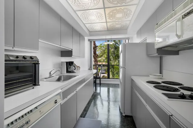 a kitchen that has a sink and a stove