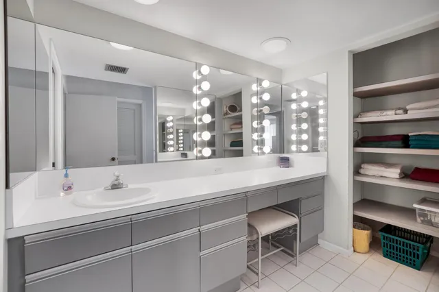 a bathroom with a sink double vanity and a mirror