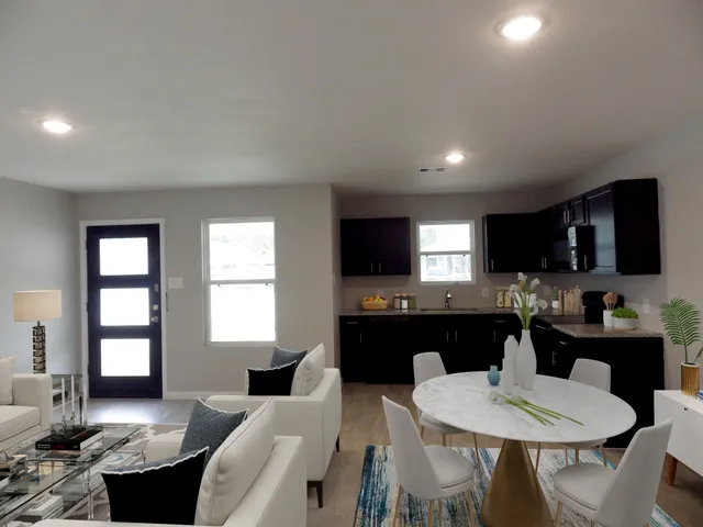 a large kitchen with a table and chairs