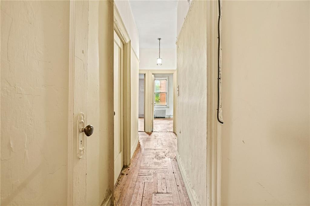 282 Buffalo Avenue Brooklyn, NY 11213 - Photo 13 of 22 a view of a hallway with wooden floor and a bathroom