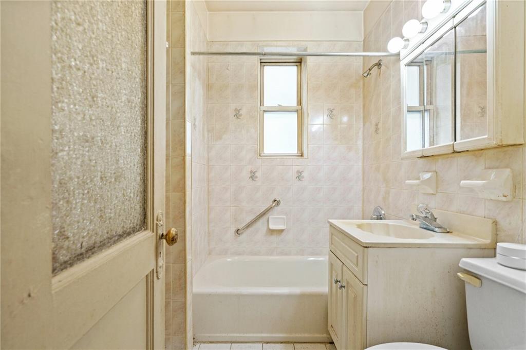 282 Buffalo Avenue Brooklyn, NY 11213 - Photo 17 of 22 a bathroom with a bathtub a shower a sink and a toilet