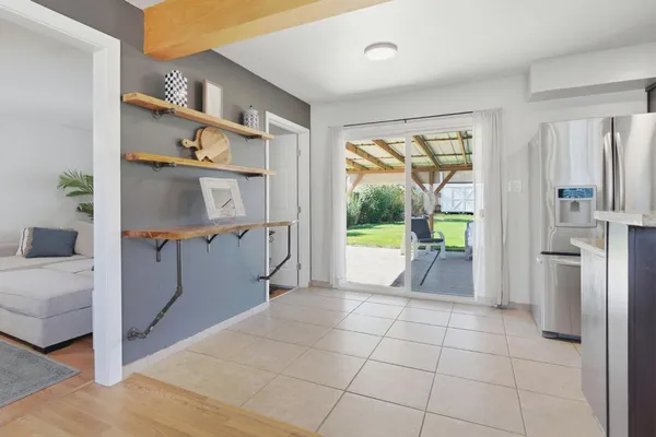 a open kitchen with cabinets and a refrigerator