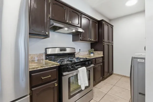 a kitchen with stainless steel appliances granite countertop a stove and a refrigerator
