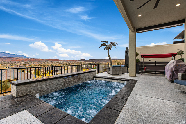 3022 West Sesia Way St. George, UT 84770 - Photo 36 of 52 View of swimming pool featuring a hot tub, area for grilling, a mountain view, and patio surround