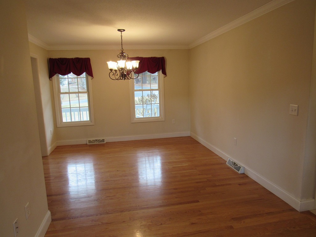 63 Valley Road Southampton, MA 01073 - Photo 4 of 18 an empty room with wooden floor and windows
