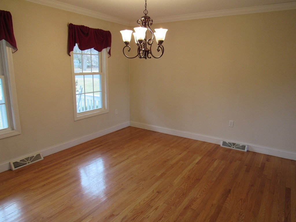 63 Valley Road Southampton, MA 01073 - Photo 5 of 18 a view of a room with wooden floor and chandelier