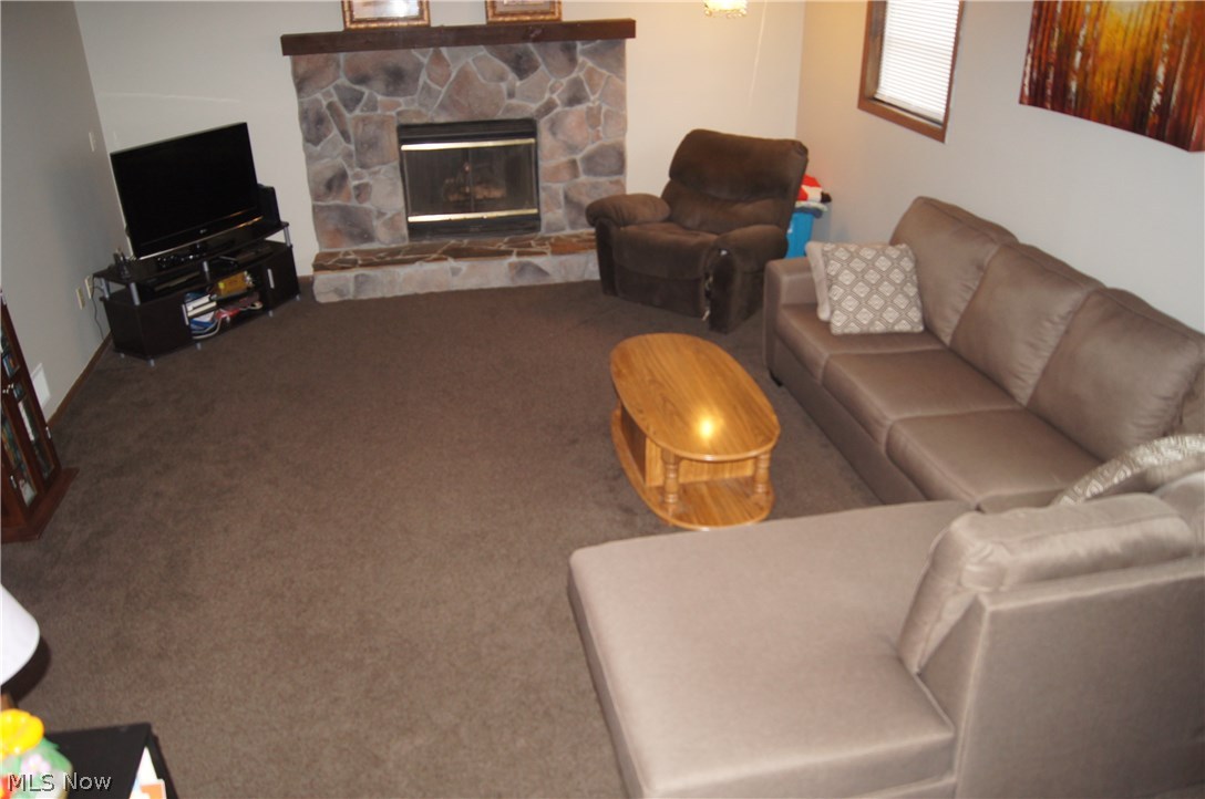 1774 Nichols Road Akron, OH 44312 - Photo 4 of 22 Family room in the lower level has a gas fireplace and has been freshly painted.