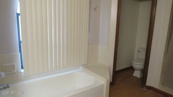 a view of a room with a ceiling fan and a window