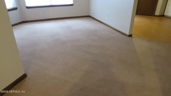 a kitchen with sink a microwave and cabinets