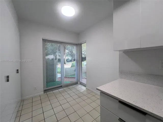 a kitchen with refrigerator cabinets and oven