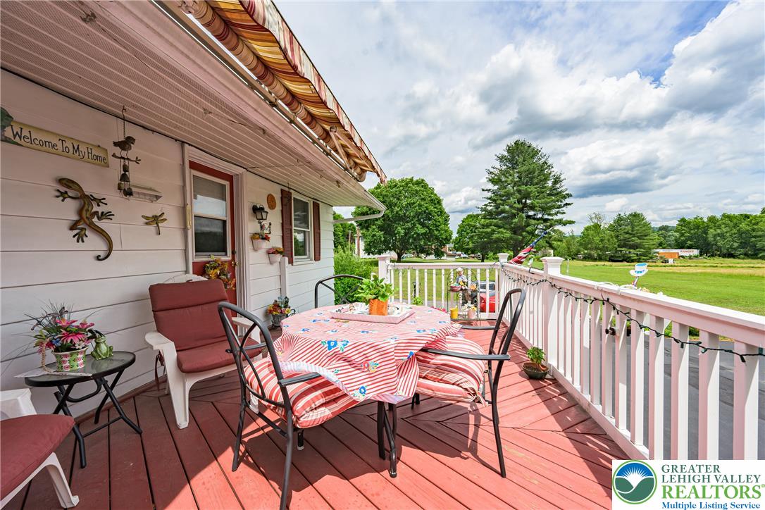 678 Interchange Road Kresgeville, PA 18333 - Photo 14 of 45 A vibrant outdoor deck with ample space for entertaining offers panoramic views of the verdant landscape.