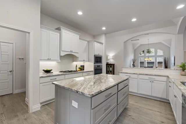 a kitchen with stainless steel appliances granite countertop a stove and a sink