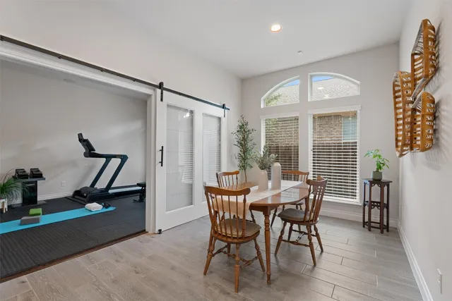 a dining room with furniture and front view of a house