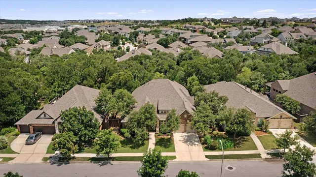 an aerial view of a house with a yard and lake view