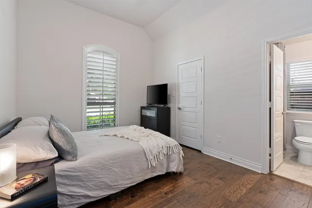 a bedroom with a bed and a television