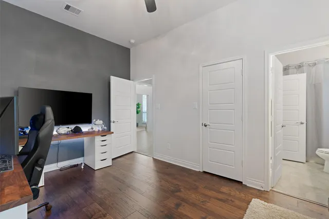 a view of a workspace with furniture and a flat screen tv