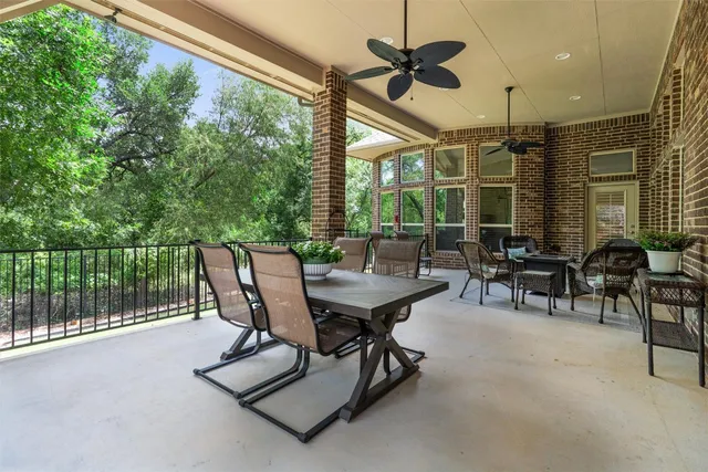 a dining room with furniture and a floor to ceiling window