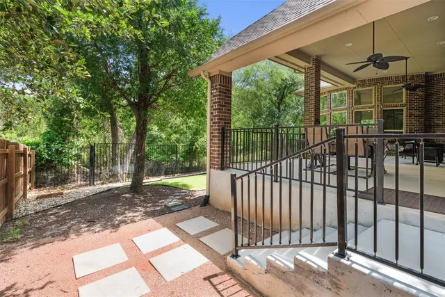 a view of a backyard with a large tree