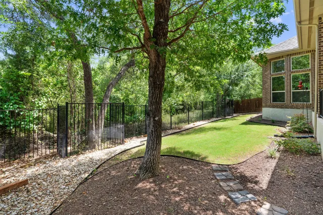 a view of a backyard with a garden and trees
