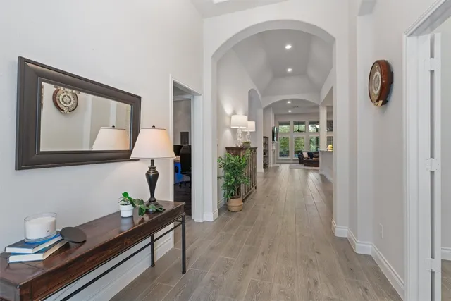 a hallway with painting on wooden floor