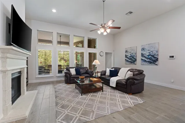 a living room with furniture a fireplace and a flat screen tv