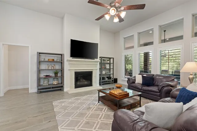 a living room with furniture a flat screen tv and a fireplace