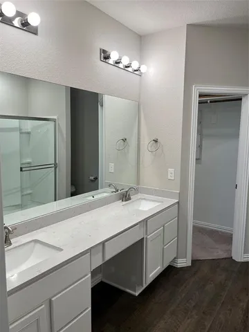 a bathroom with a shower and a mirror
