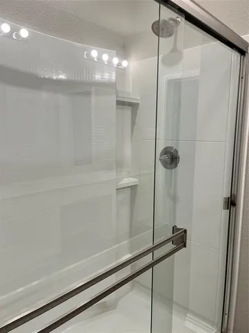 a bathroom with a glass shower door