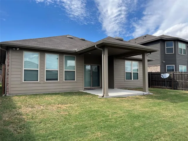 a swimming pool with trees in front of it