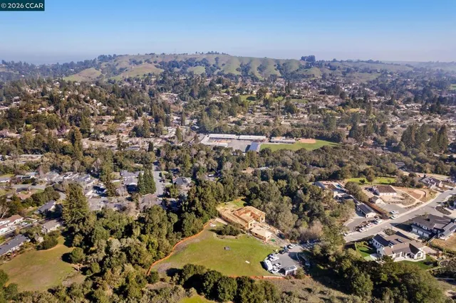 an aerial view of a house with a yard