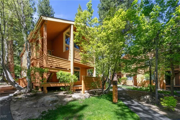 a view of a chair and table in backyard of the house