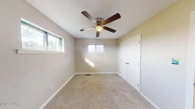 a view of room with window and ceiling fan
