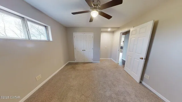 a view of a hallway with wooden floor and entryway