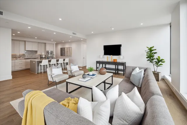 a view of a livingroom with furniture and floor to ceiling window