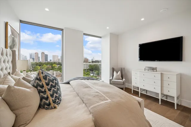 a living room with lots of furniture and a large window