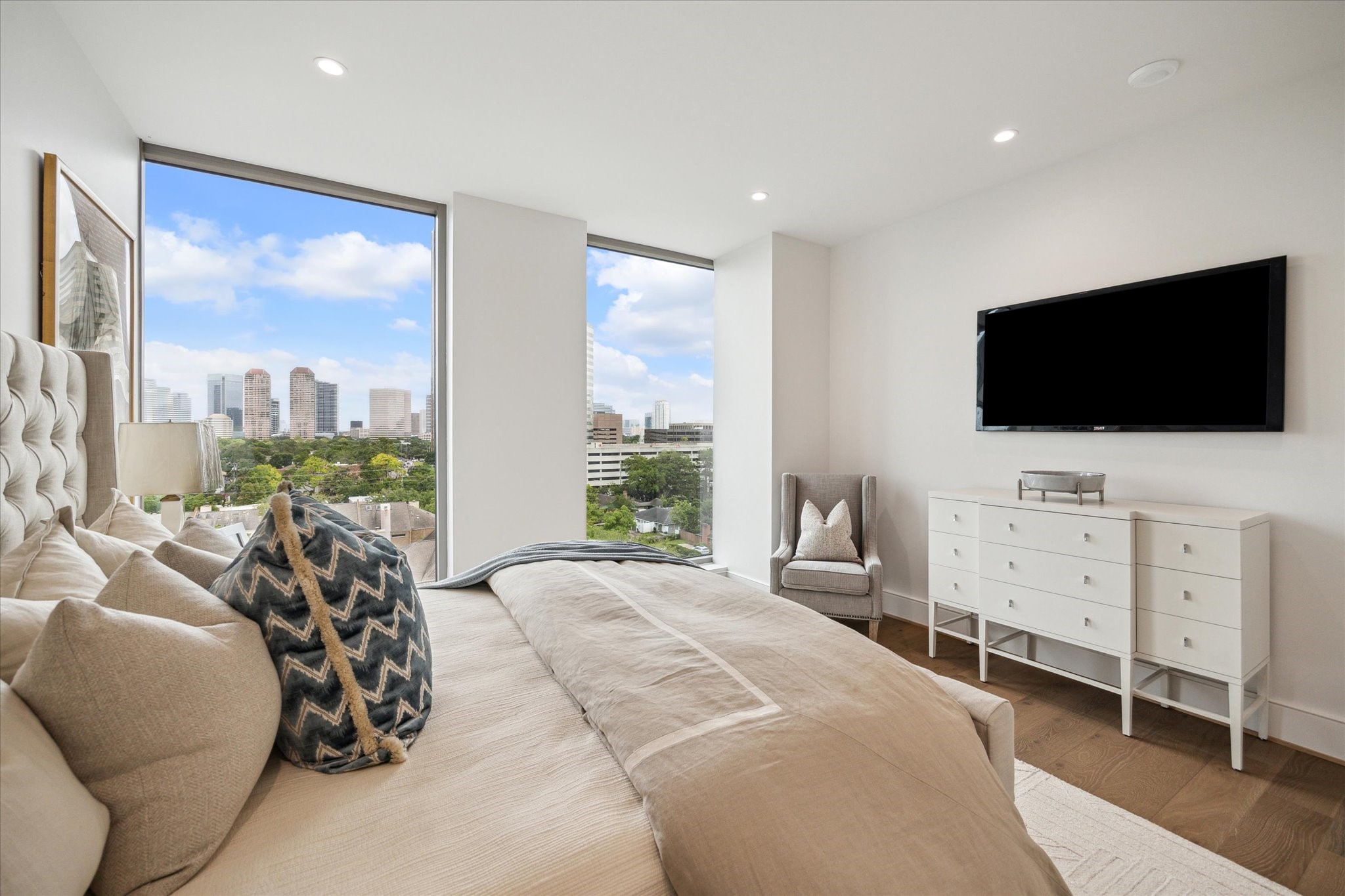 5656 San Felipe Street, Unit 701 Houston, TX 77056 - Photo 36 of 45 a bedroom with furniture and a flat screen tv