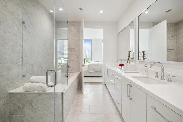 a living room with furniture a flat screen tv and kitchen view