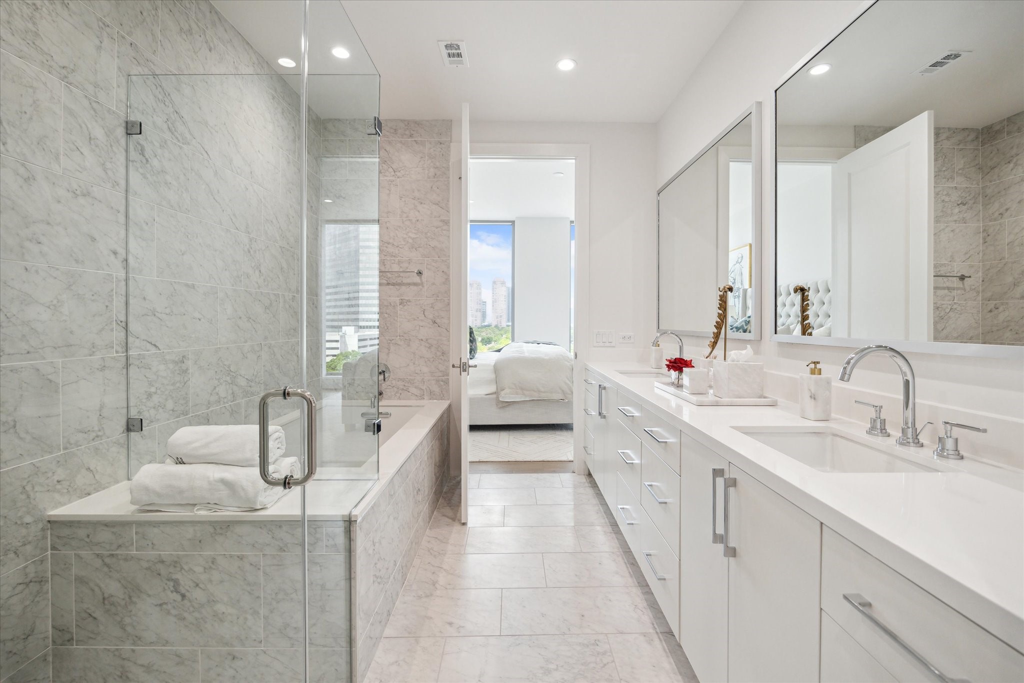 5656 San Felipe Street, Unit 701 Houston, TX 77056 - Photo 37 of 45 a spacious en suite bathroom with a double vanity sink a large mirror and a bathtub