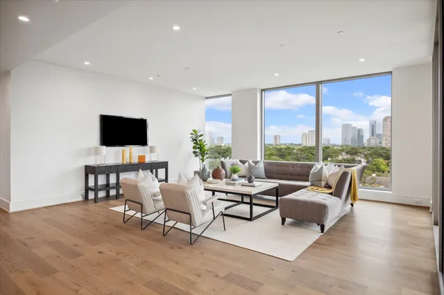 a bedroom with furniture and a flat screen tv