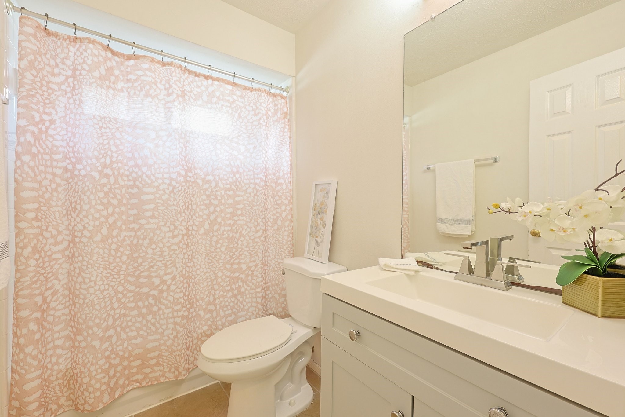 23019 Eastgate Village Drive Spring, TX 77373 - Photo 32 of 46 Bright and modern bathroom featuring vanity, large mirror, and a white toilet.