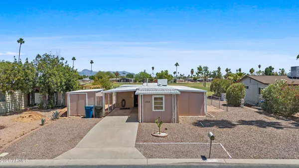 a living room with furniture a window and a flat screen tv